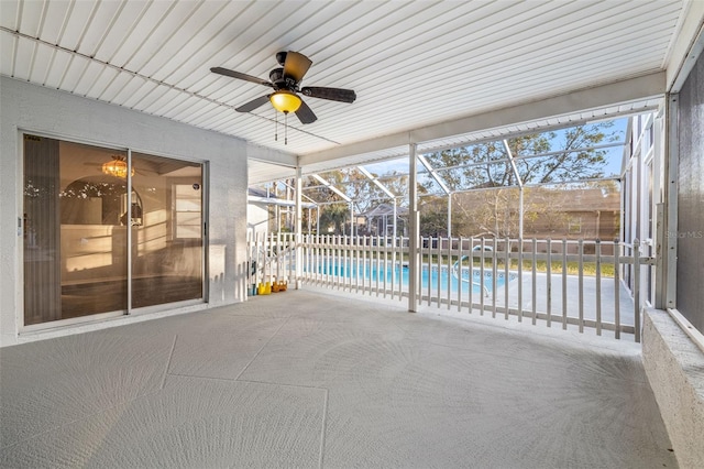 unfurnished sunroom featuring ceiling fan