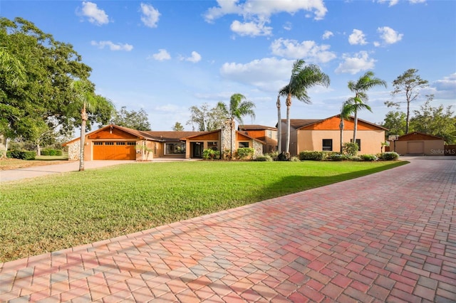 view of front of house with a front yard and a garage