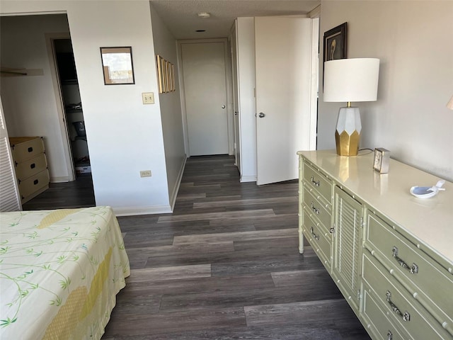 bedroom with dark hardwood / wood-style flooring and a textured ceiling