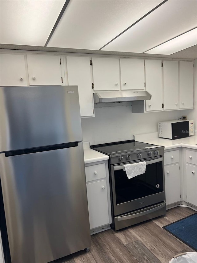 kitchen featuring white cabinets, appliances with stainless steel finishes, and dark wood-type flooring