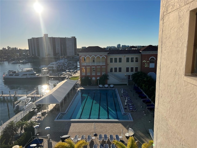 view of pool featuring a patio area and a water view