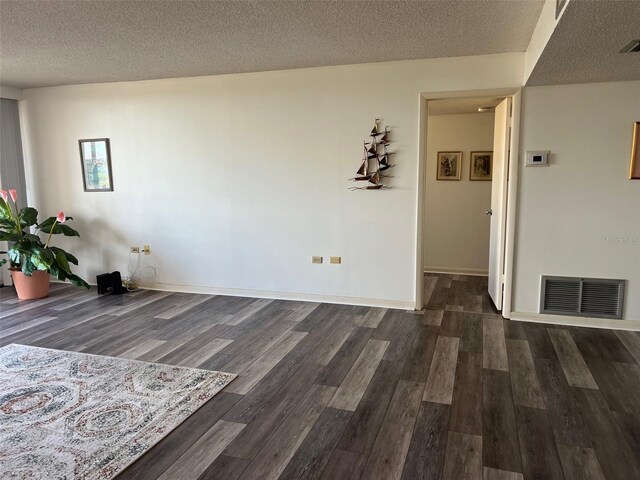 interior space featuring dark hardwood / wood-style flooring and a textured ceiling