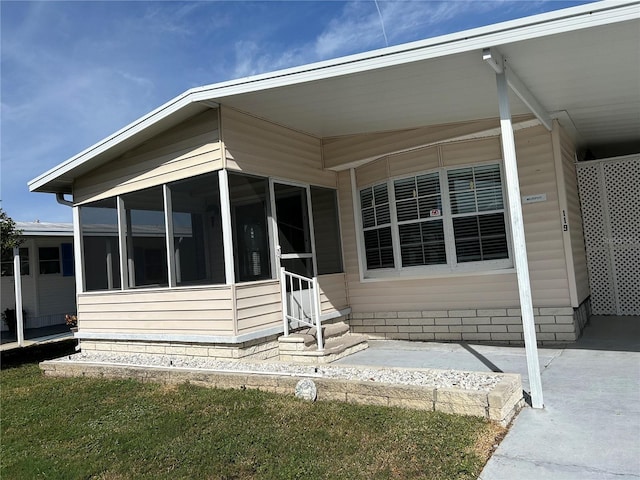 back of property featuring a sunroom