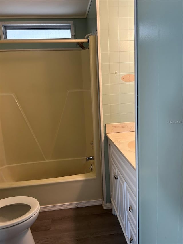 full bathroom featuring a wealth of natural light, wood-type flooring, toilet, and shower / bathtub combination