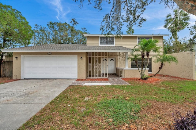 front facade featuring a front lawn and a garage