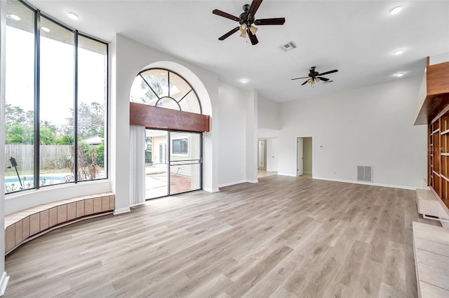 unfurnished living room featuring ceiling fan and light hardwood / wood-style flooring