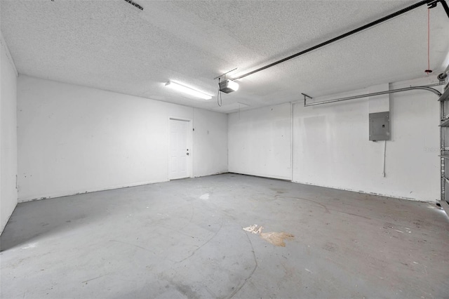 garage featuring electric panel and a garage door opener