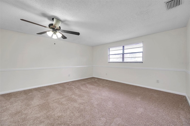 carpeted empty room featuring ceiling fan and a textured ceiling