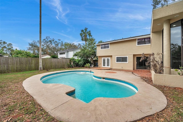 view of pool featuring a patio area and french doors