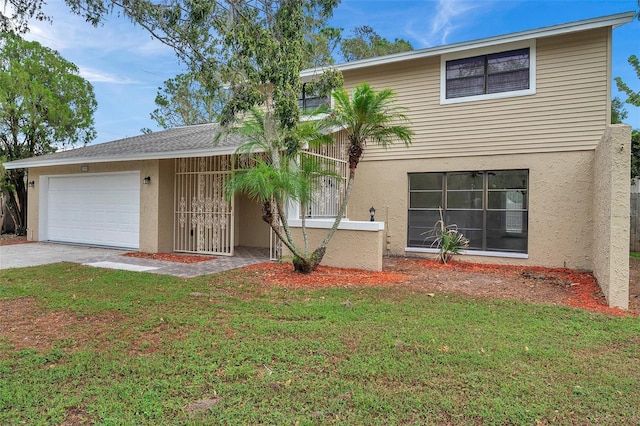 view of front of home with a front yard and a garage