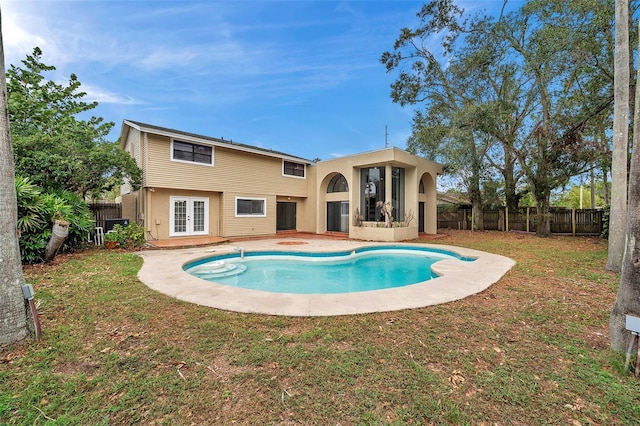 view of pool featuring a lawn and french doors