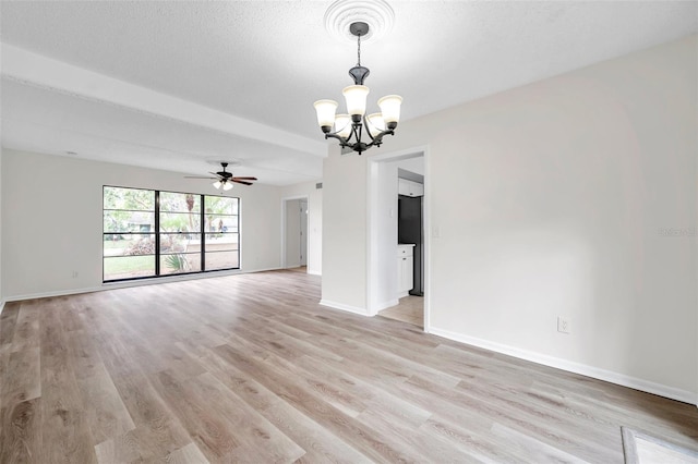 spare room featuring ceiling fan with notable chandelier, light hardwood / wood-style floors, and a textured ceiling