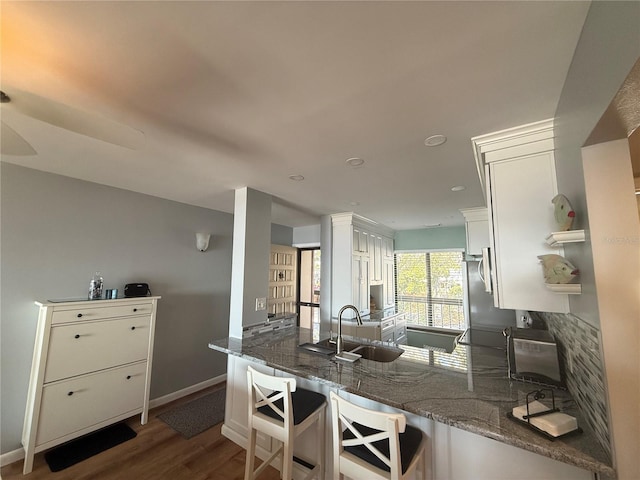 6268 Palma Del Mar Blvd S Unit 215, Saint Petersburg, FL 33715 - kitchen with a sink, white cabinetry, dark wood finished floors, and stone counters