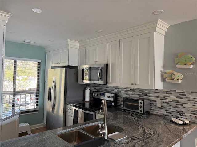 6268 Palma Del Mar Blvd S Unit 215, Saint Petersburg, FL 33715 - kitchen featuring appliances with stainless steel finishes, tasteful backsplash, white cabinets, a sink, and recessed lighting