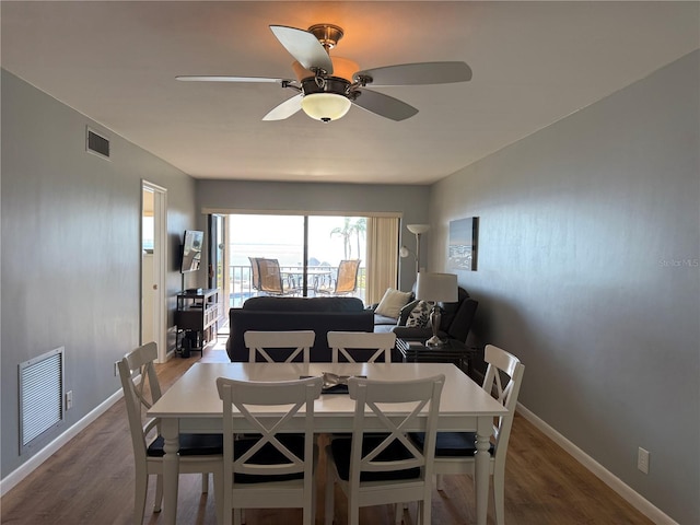6268 Palma Del Mar Blvd S Unit 215, Saint Petersburg, FL 33715 - dining space featuring ceiling fan, wood finished floors, and baseboards