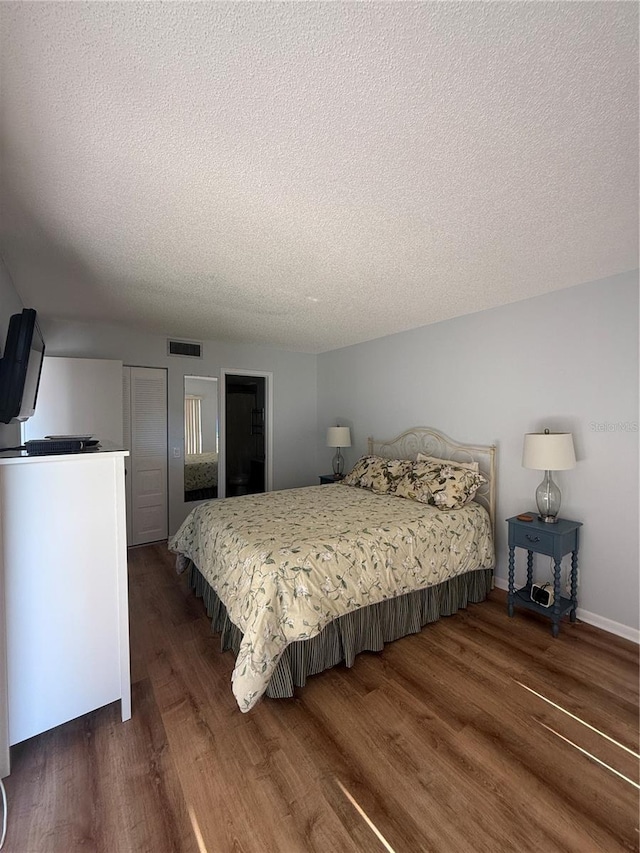 6268 Palma Del Mar Blvd S Unit 215, Saint Petersburg, FL 33715 - bedroom featuring wood finished floors, a textured ceiling, and baseboards