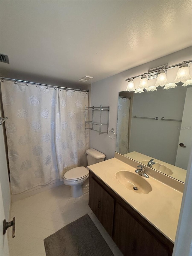 6268 Palma Del Mar Blvd S Unit 215, Saint Petersburg, FL 33715 - bathroom featuring toilet, vanity, tile patterned floors, and curtained shower