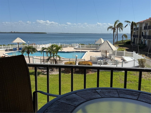 balcony featuring a water view and a patio area