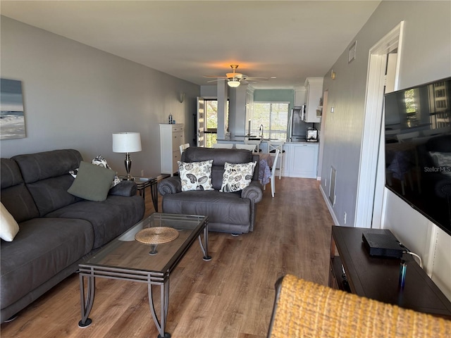 6268 Palma Del Mar Blvd S Unit 215, Saint Petersburg, FL 33715 - living room featuring wood finished floors and a ceiling fan