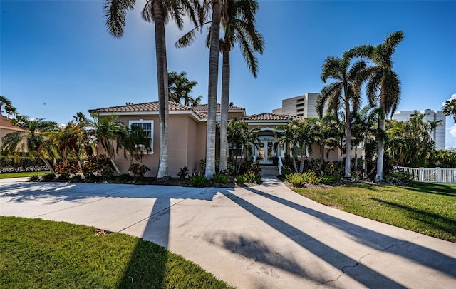 mediterranean / spanish home featuring a front yard