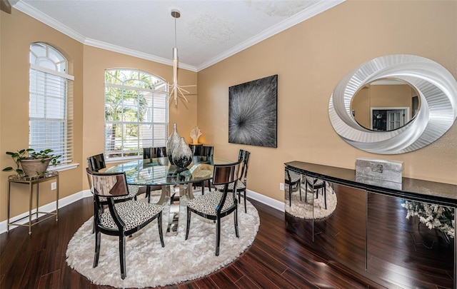 dining room with dark hardwood / wood-style flooring, a textured ceiling, and ornamental molding