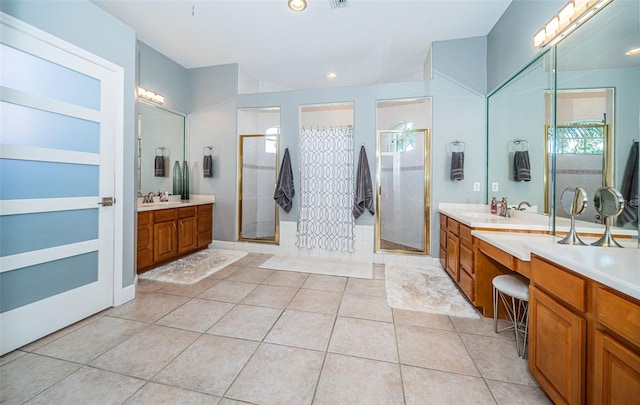 bathroom featuring tile patterned flooring, vanity, and walk in shower