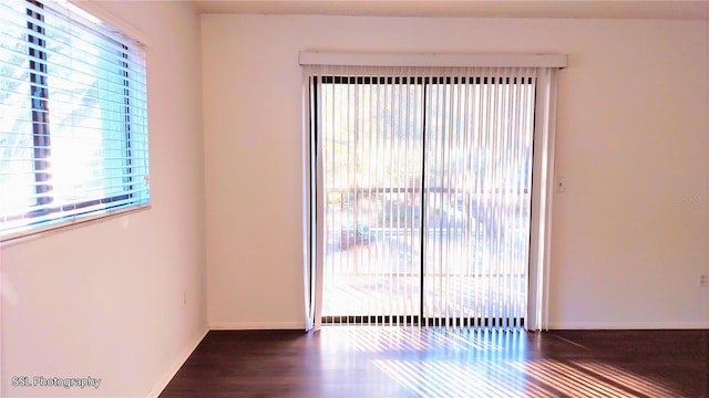 empty room featuring dark wood-type flooring