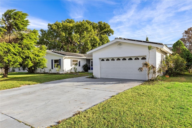 single story home featuring a garage and a front lawn