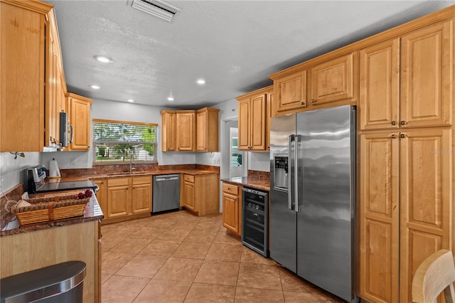 2516 Roberta St, Largo, FL 33771 - kitchen featuring appliances with stainless steel finishes, wine cooler, a sink, recessed lighting, and light tile patterned floors