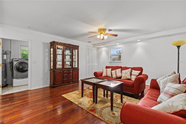 living room featuring hardwood / wood-style floors, ceiling fan, and washer / dryer