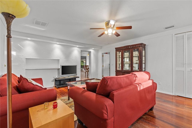 living room with hardwood / wood-style flooring and ceiling fan