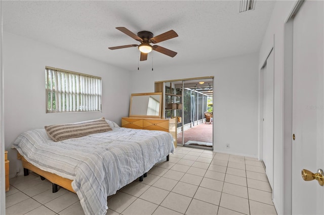 2516 Roberta St, Largo, FL 33771 - bedroom featuring access to exterior, light tile patterned flooring, a textured ceiling, and ceiling fan
