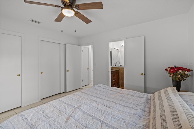 tiled bedroom featuring ensuite bathroom and ceiling fan