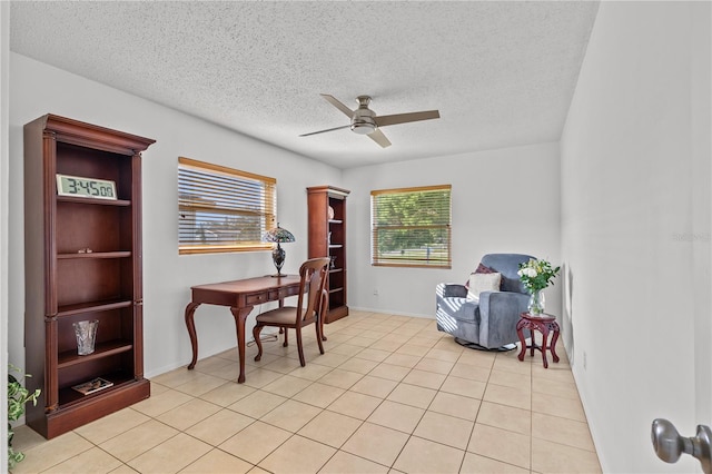 office space featuring ceiling fan, a healthy amount of sunlight, and a textured ceiling