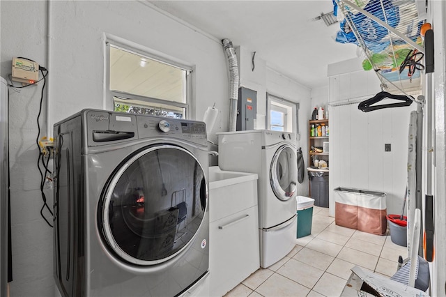2516 Roberta St, Largo, FL 33771 - washroom featuring cabinet space, washer and clothes dryer, light tile patterned floors, and electric panel