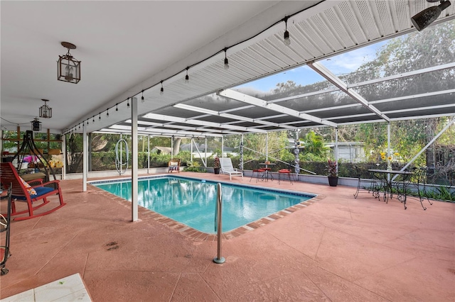 view of swimming pool featuring a lanai and a patio