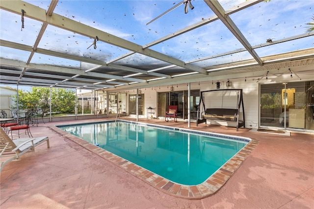 view of pool with a patio area and a lanai