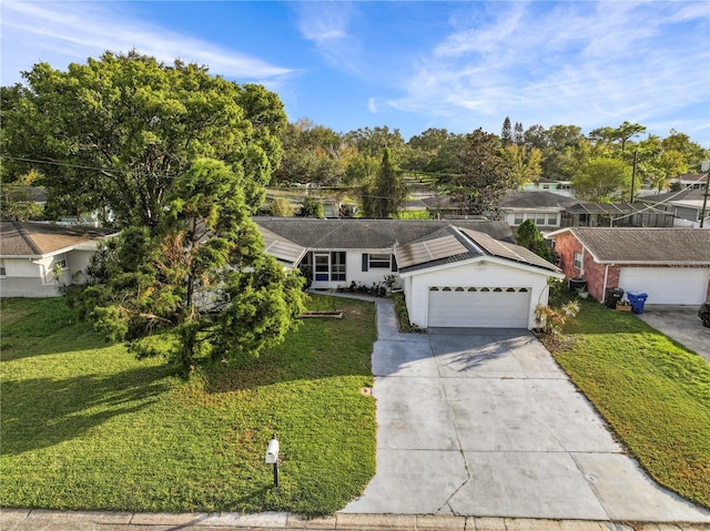 2516 Roberta St, Largo, FL 33771 - ranch-style home featuring concrete driveway, a front yard, solar panels, and a garage