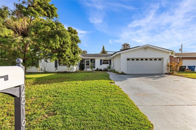 2516 Roberta St, Largo, FL 33771 - ranch-style house featuring an attached garage, driveway, and a front lawn