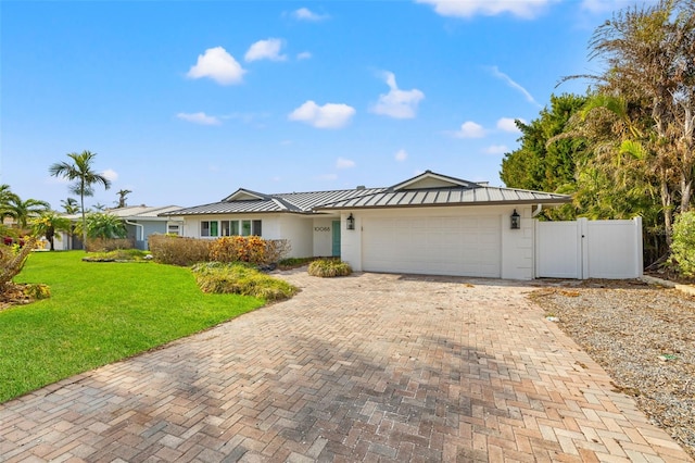 ranch-style home with a garage and a front yard