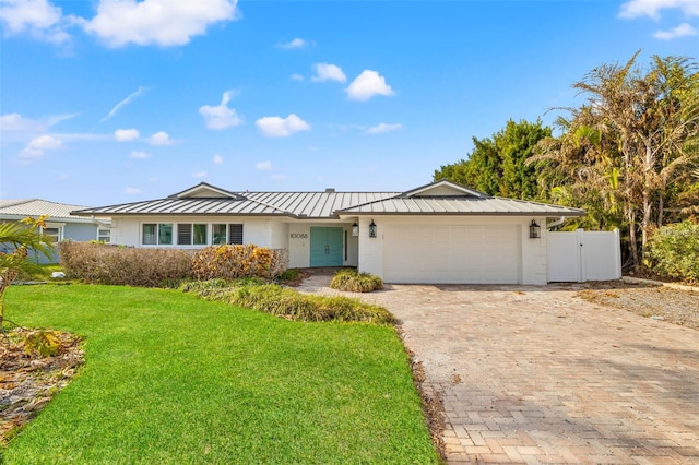 ranch-style home with a front lawn and a garage