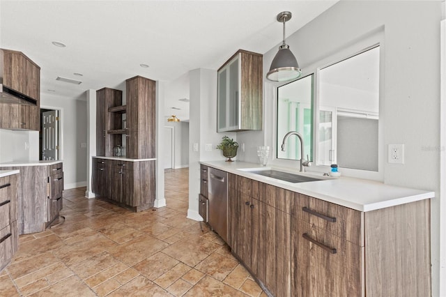 kitchen with sink, stainless steel dishwasher, and decorative light fixtures