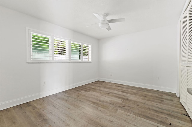 unfurnished bedroom with ceiling fan, wood-type flooring, and a closet