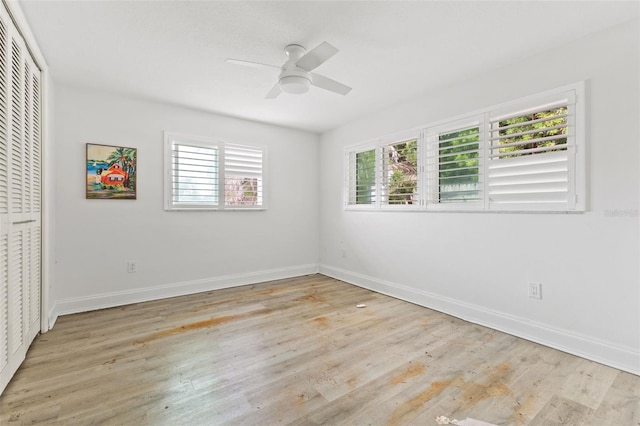 unfurnished bedroom with ceiling fan, multiple windows, and a closet