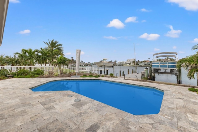 view of pool featuring a water view, a patio, and a boat dock