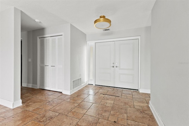 entrance foyer featuring a textured ceiling