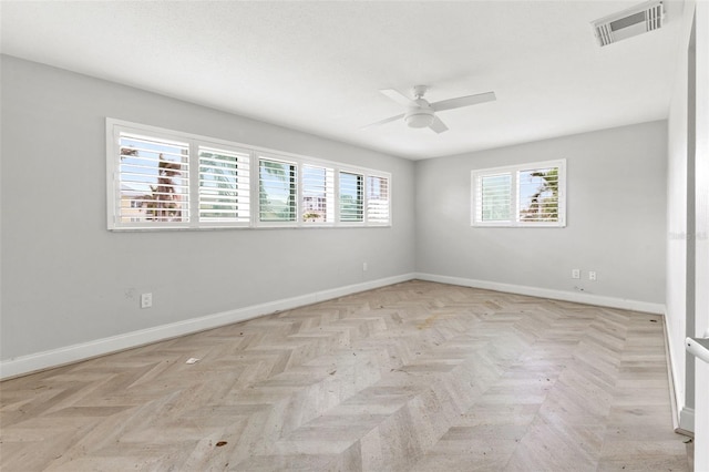 unfurnished room with ceiling fan and light parquet flooring