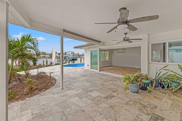 view of patio / terrace with a water view and ceiling fan