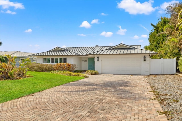 ranch-style house with a front yard and a garage