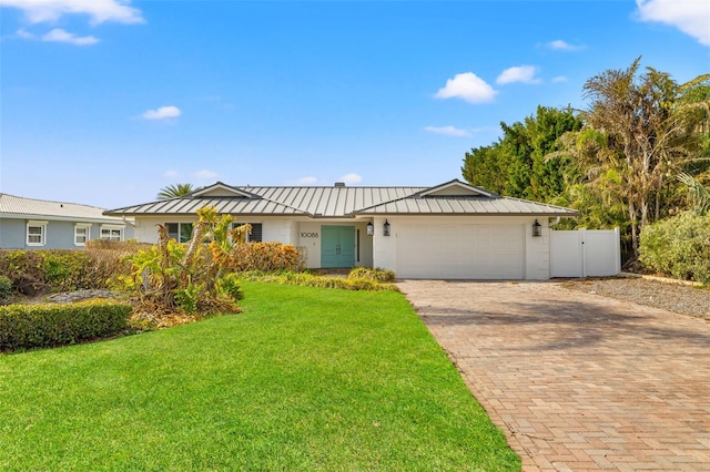 ranch-style house featuring a front yard and a garage